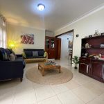 Comfortable guest lounge with sofas and African artwork, JOSIRE Residence