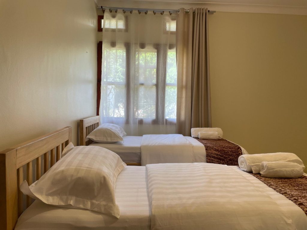 Twin room with two single beds and sheer curtains, JOSIRE Residence